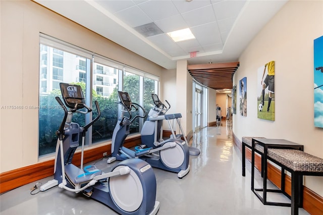 exercise room with a tray ceiling