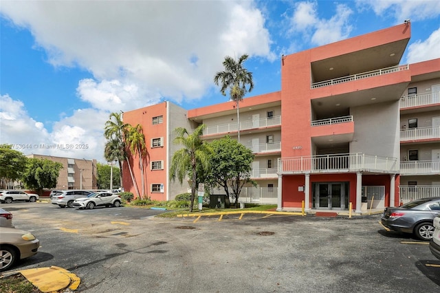 view of building exterior featuring uncovered parking