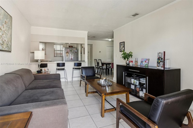 living room featuring light tile patterned floors and visible vents