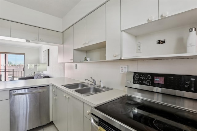 8425 NW 8th St Unit 404, Miami, FL 33126 - kitchen with appliances with stainless steel finishes, open shelves, light countertops, and white cabinetry
