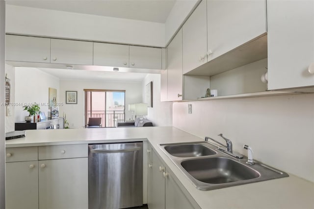 kitchen featuring a peninsula, a sink, light countertops, stainless steel dishwasher, and open shelves