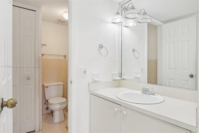 full bath featuring a closet, tile walls, toilet, and tile patterned floors