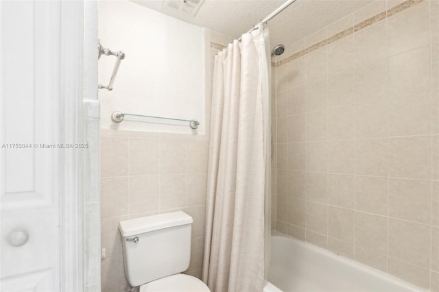 full bath featuring a textured ceiling, toilet, visible vents, tile walls, and shower / tub combo with curtain