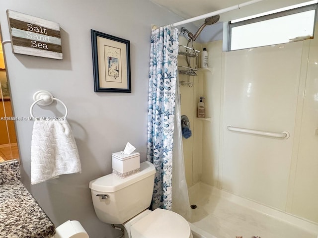 full bathroom featuring a shower stall and toilet