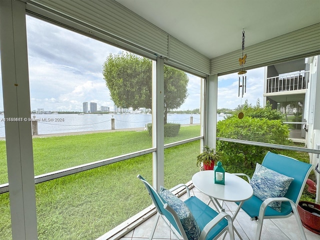 sunroom featuring a water view