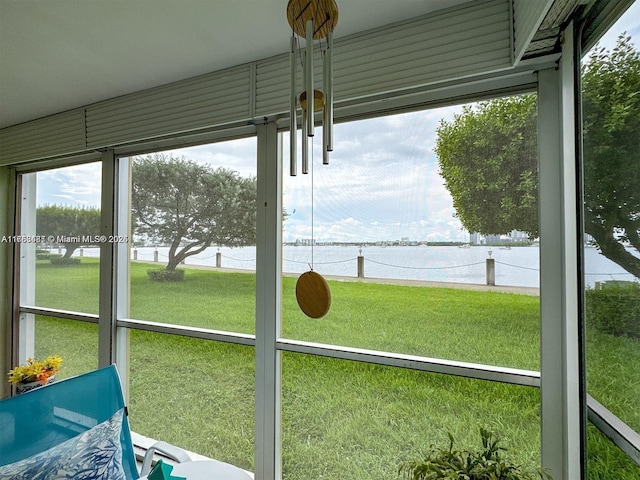 unfurnished sunroom with a water view