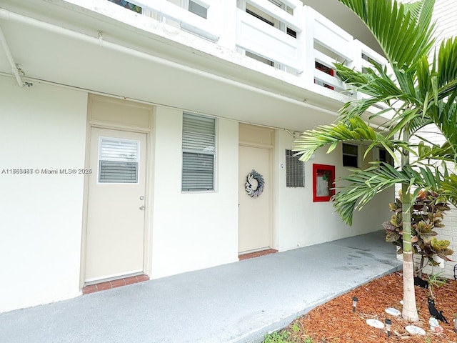 doorway to property with stucco siding