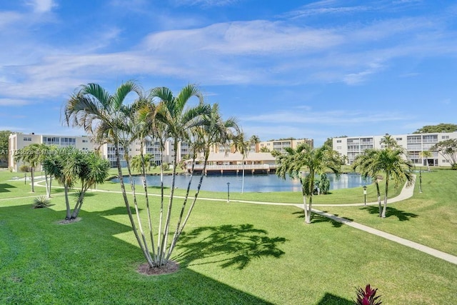 view of property's community featuring a yard and a water view