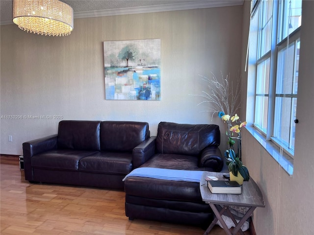 living area with ornamental molding and wood finished floors