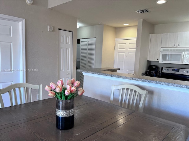 unfurnished dining area featuring visible vents and recessed lighting