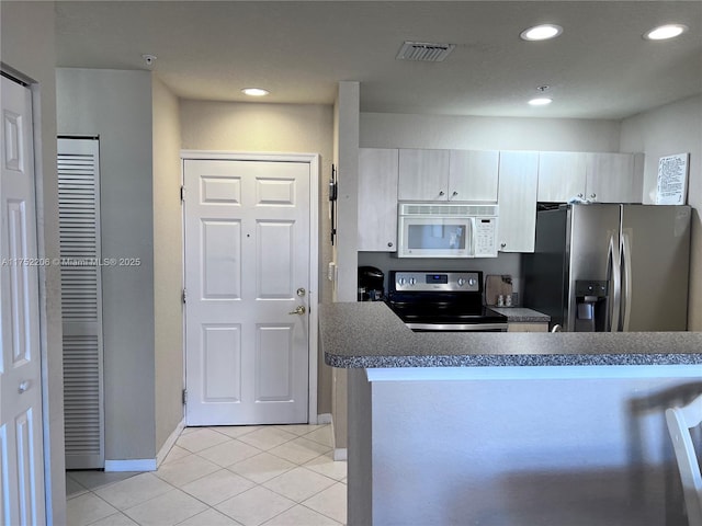 kitchen featuring light tile patterned floors, stainless steel appliances, recessed lighting, visible vents, and baseboards