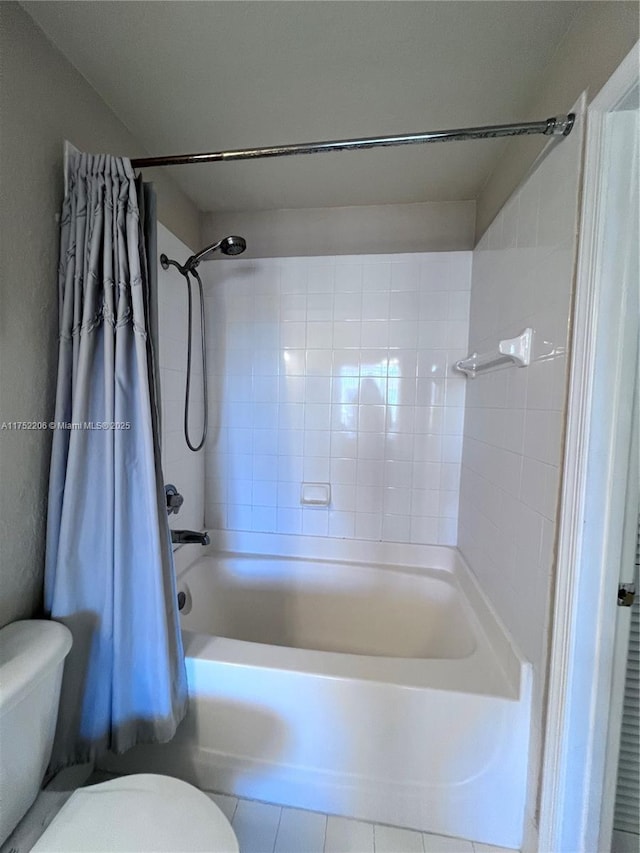 full bath featuring shower / tub combo with curtain, toilet, and tile patterned floors