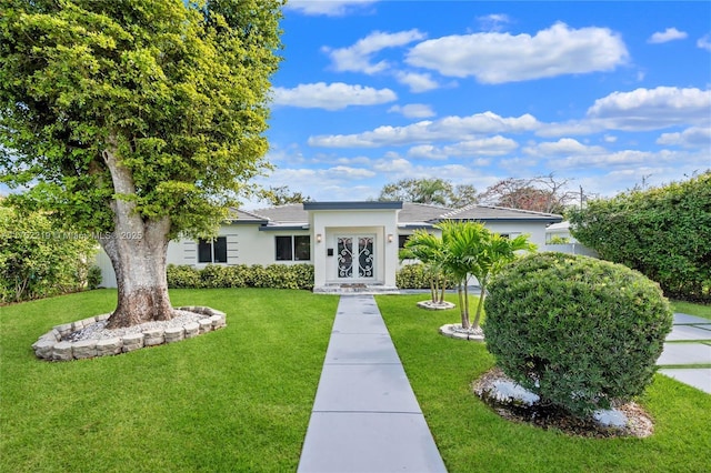 view of front of house with a front lawn and stucco siding