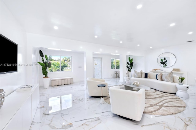 living area featuring marble finish floor, visible vents, and recessed lighting