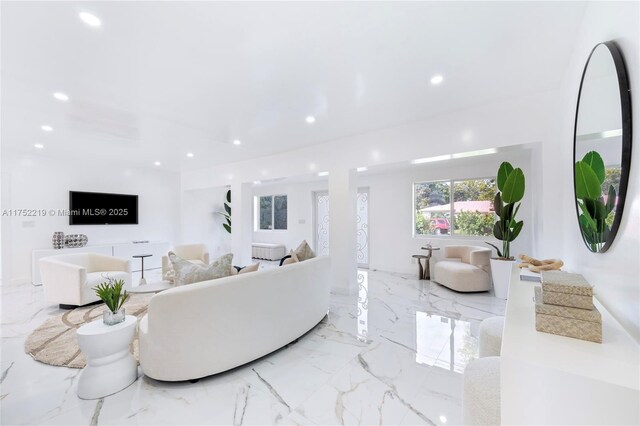 living area featuring marble finish floor and recessed lighting