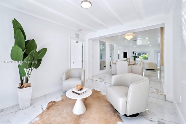 living area with marble finish floor, visible vents, baseboards, and beamed ceiling