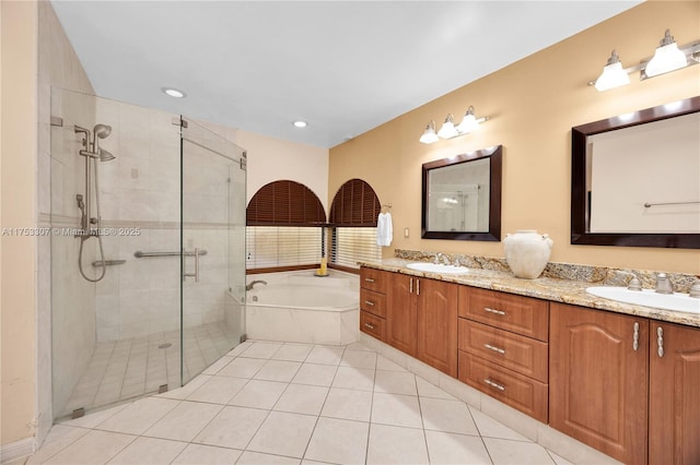 bathroom featuring double vanity, a stall shower, a sink, and a bath