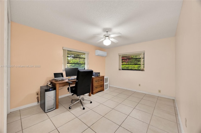 home office with a textured ceiling, light tile patterned floors, a ceiling fan, baseboards, and a wall mounted AC