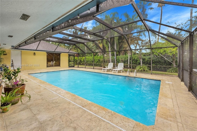 pool with a lanai and a patio