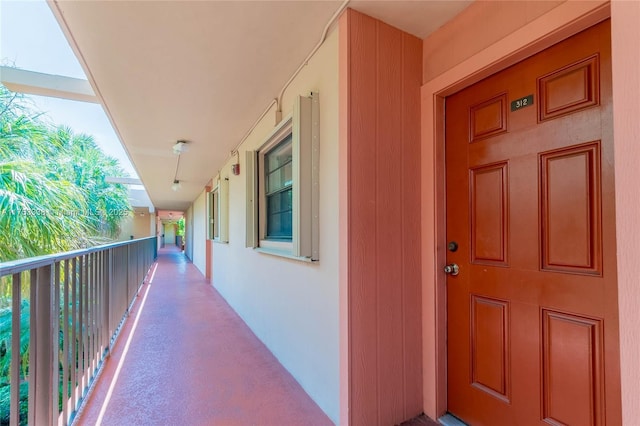 doorway to property featuring a balcony and stucco siding