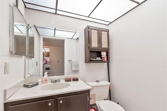 bathroom with toilet and vanity