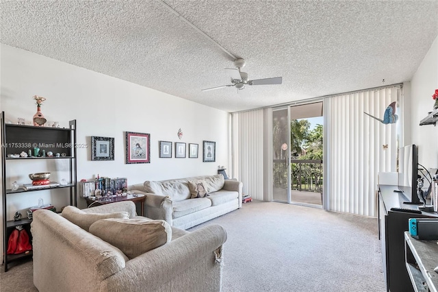 carpeted living area featuring a textured ceiling, a ceiling fan, and floor to ceiling windows