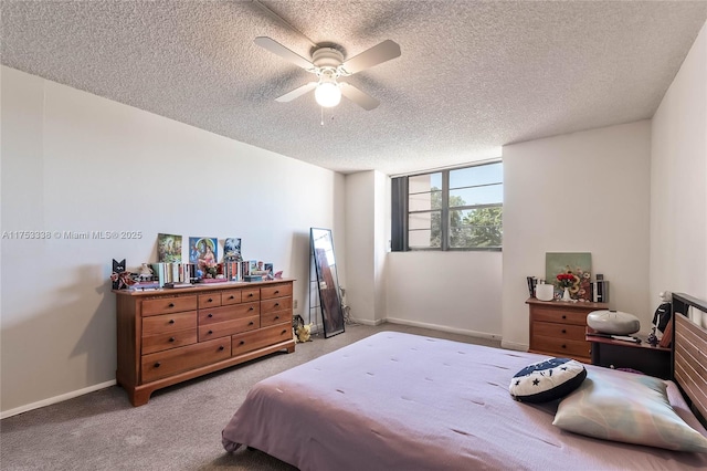 carpeted bedroom featuring ceiling fan, baseboards, and a textured ceiling