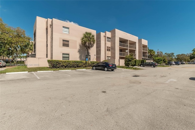 view of building exterior featuring uncovered parking