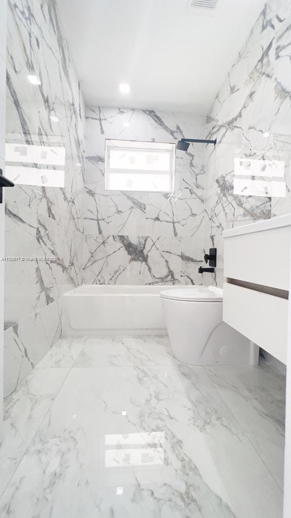 1013 NW 1st Ave, Hallandale Beach, FL 33009 - bathroom with stone wall, toilet, vanity, and shower / bathtub combination