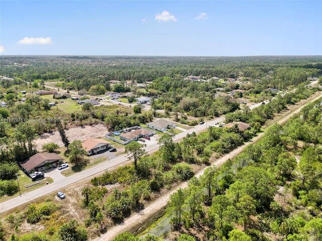 birds eye view of property with a view of trees