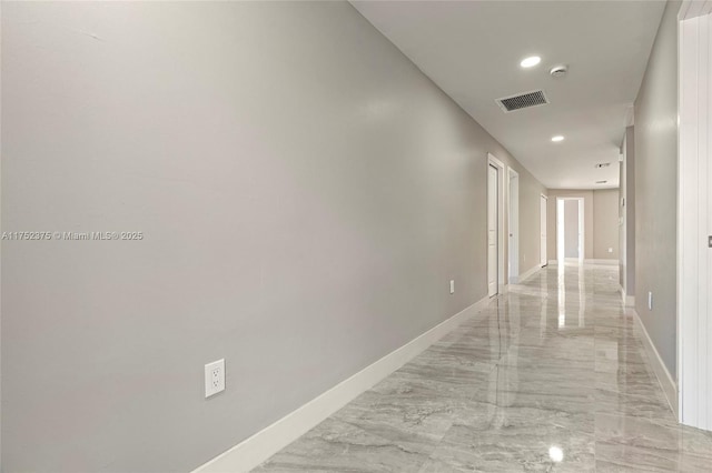 hallway with recessed lighting, marble finish floor, visible vents, and baseboards