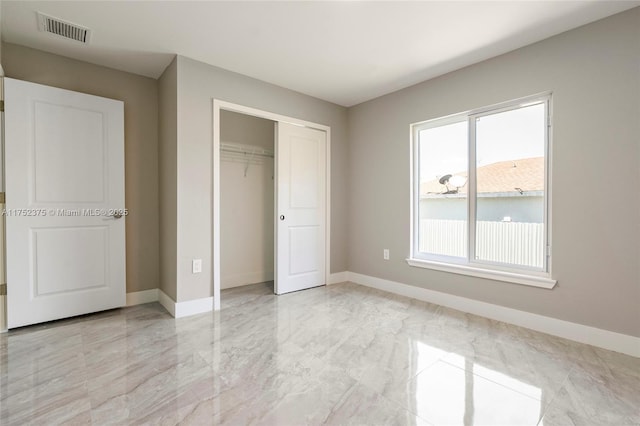 unfurnished bedroom featuring a closet, visible vents, marble finish floor, and baseboards