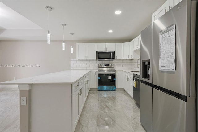 kitchen featuring marble finish floor, decorative backsplash, appliances with stainless steel finishes, white cabinets, and a peninsula