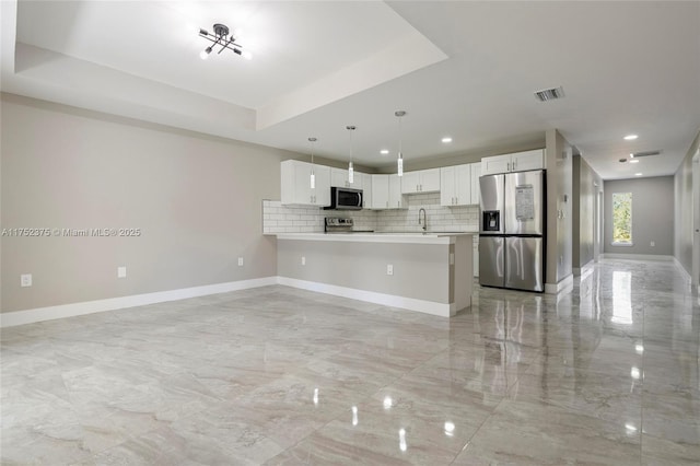 kitchen featuring visible vents, a raised ceiling, baseboards, appliances with stainless steel finishes, and marble finish floor