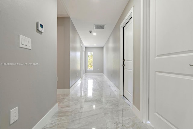 hallway featuring marble finish floor, baseboards, visible vents, and recessed lighting