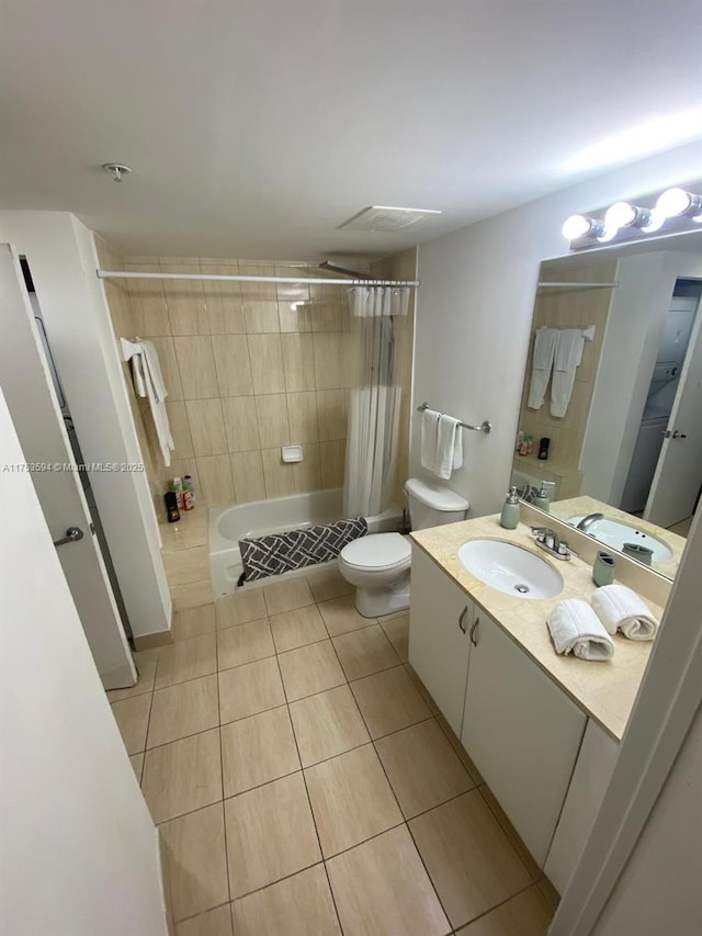 bathroom featuring toilet, vanity, shower / tub combo with curtain, and tile patterned floors