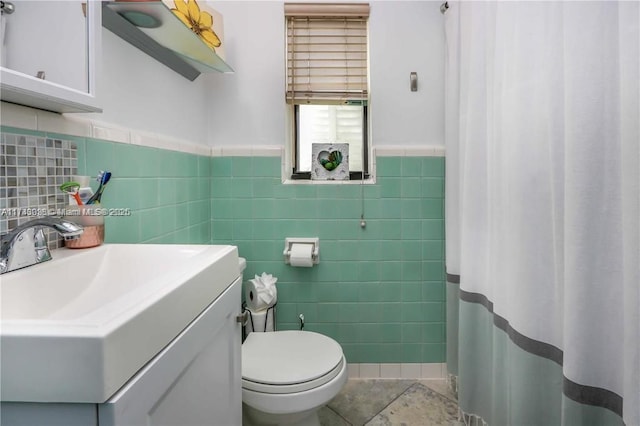 full bathroom with tile patterned flooring, toilet, vanity, tile walls, and a shower with curtain