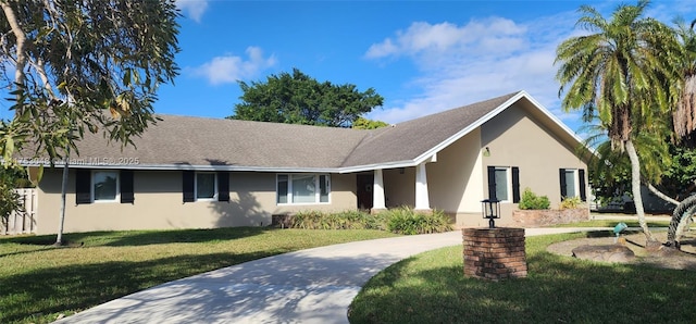 ranch-style house with stucco siding and a front yard