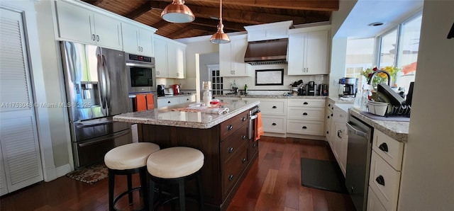 kitchen featuring wooden ceiling, under cabinet range hood, stainless steel appliances, dark wood-type flooring, and a kitchen island