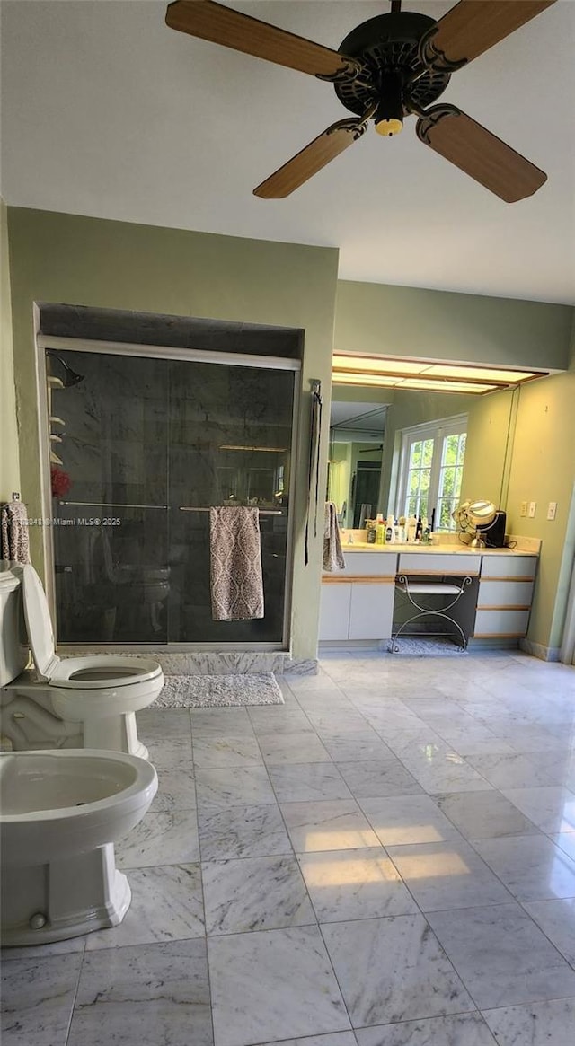 bathroom featuring a stall shower, marble finish floor, vanity, and toilet