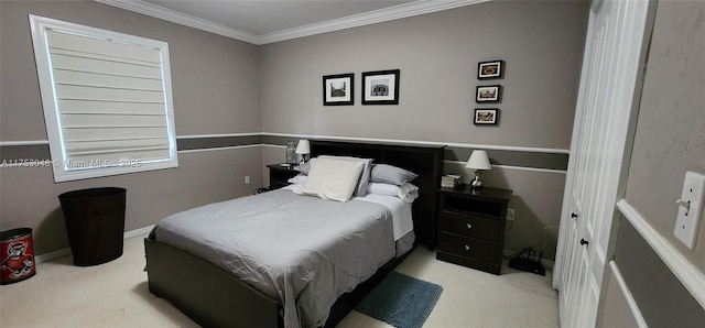 carpeted bedroom featuring crown molding and baseboards