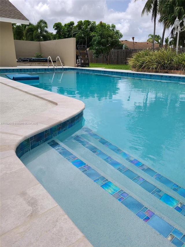 view of pool featuring fence, a fenced in pool, and a patio