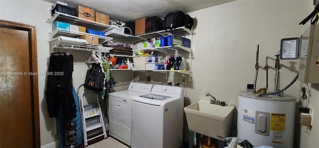 laundry room with laundry area, a sink, water heater, electric panel, and washer and clothes dryer