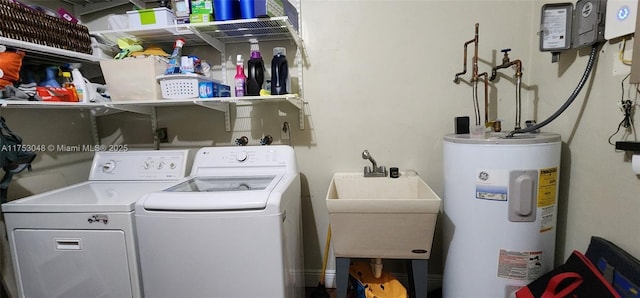 laundry area featuring laundry area, water heater, independent washer and dryer, and a sink