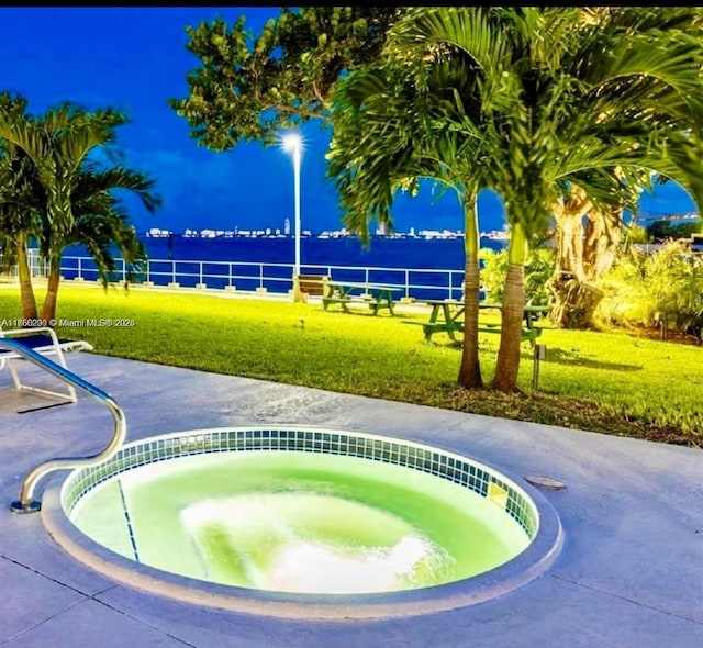 view of community with a yard and a hot tub