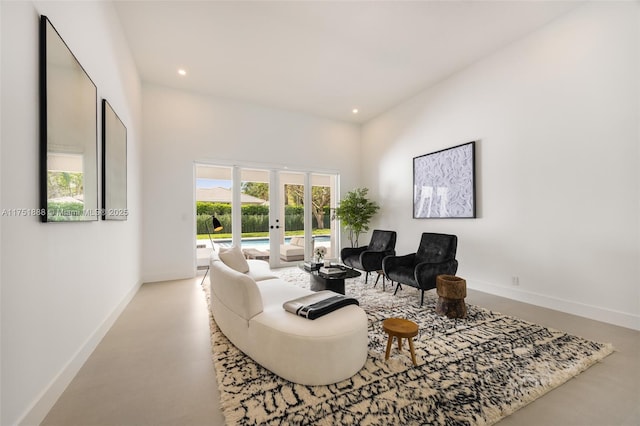 living area with recessed lighting, baseboards, and french doors