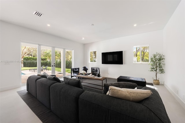 living room featuring french doors, plenty of natural light, visible vents, and recessed lighting