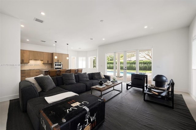 living room featuring baseboards, french doors, visible vents, and recessed lighting