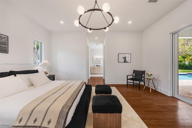 bedroom with access to outside, multiple windows, wood finished floors, and recessed lighting