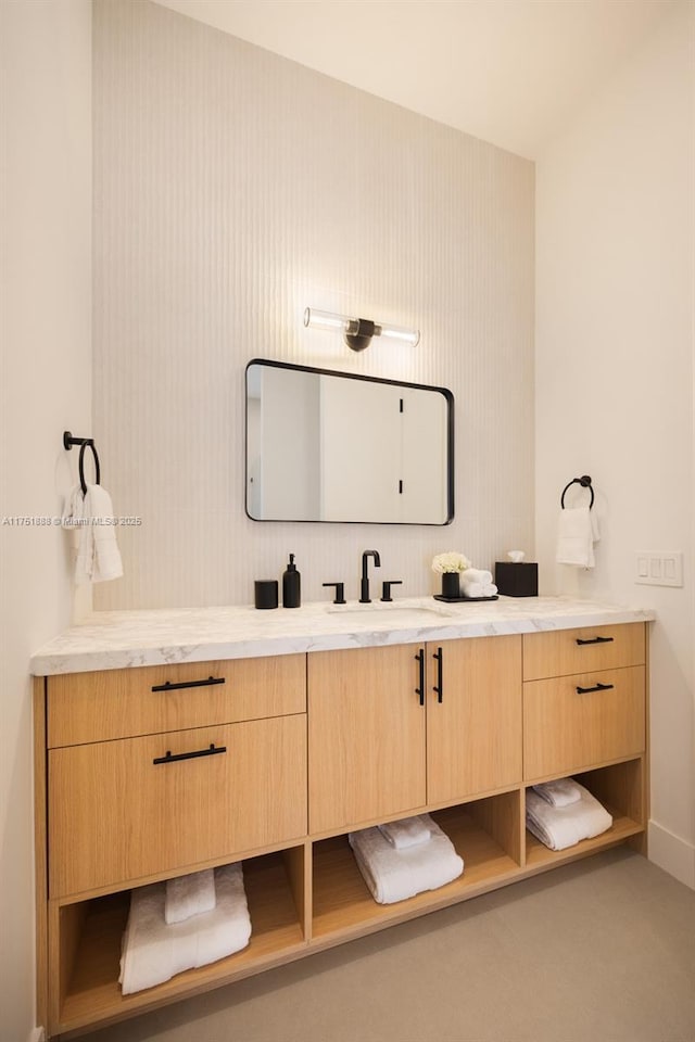 bathroom featuring baseboards and vanity